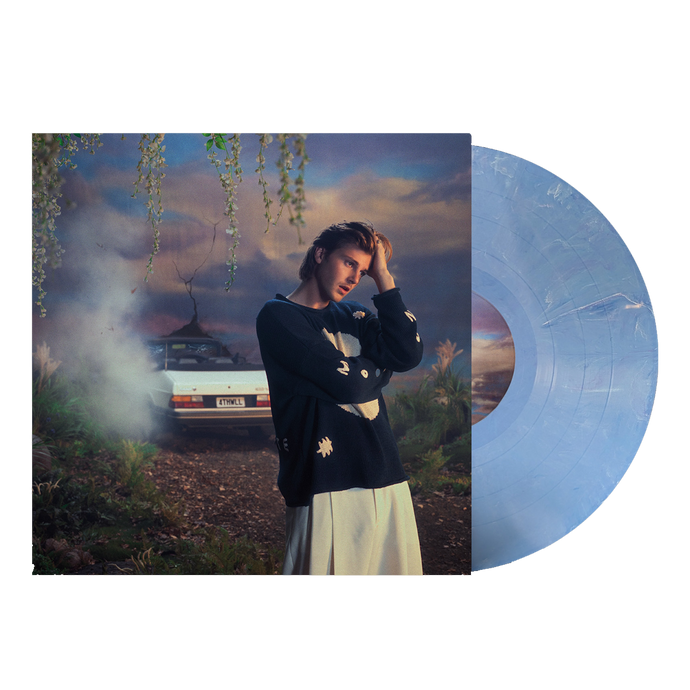 Ruel 4th wall vinyl with blue and white marbled record coming out of sleeve