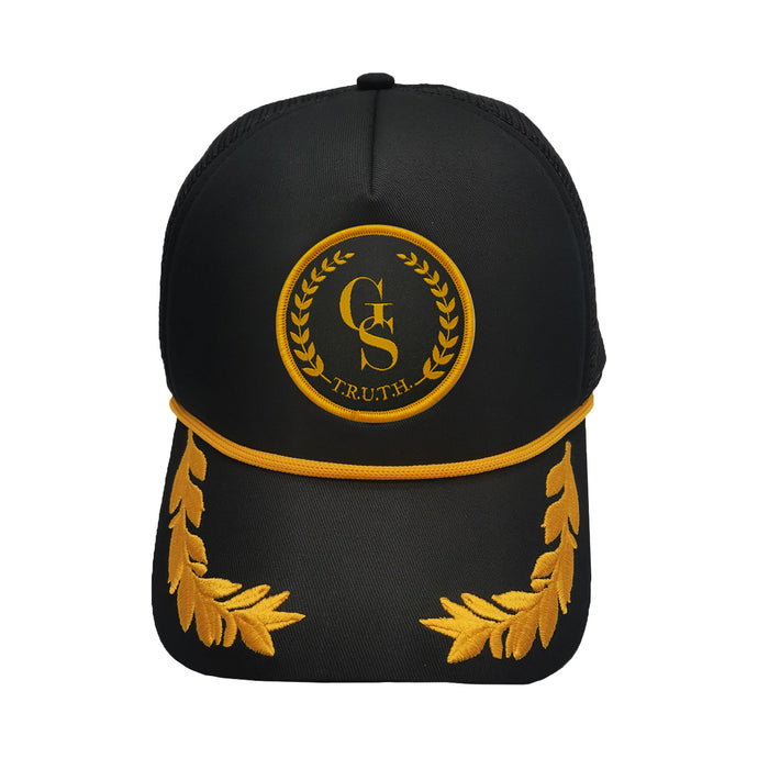 Black and gold trucker cap with gold embroidered leaf on peak, and GS Truth Emblem logo patch on front