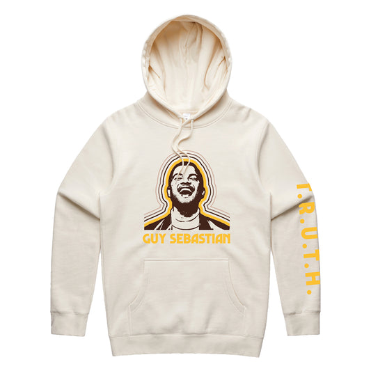 Cream hoodie with Guy Sebastians face on front in brown, with consecutive yellow and brown lines around the head. TRUTH in yellow on sleeve